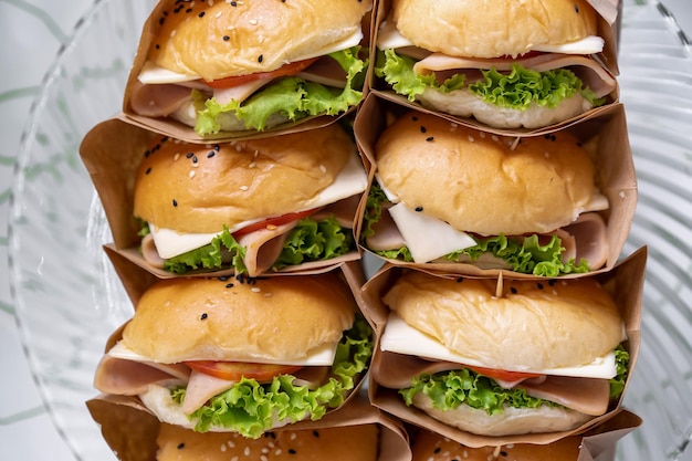 Photo un groupe de hamburger fait maison est enveloppé de papier artisanal et disposé sur le plat prêt à servir et à manger
