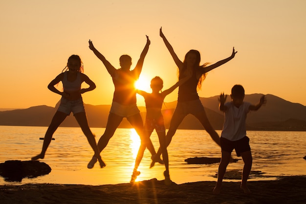 Un groupe de jeunes dansant sur l'océan.