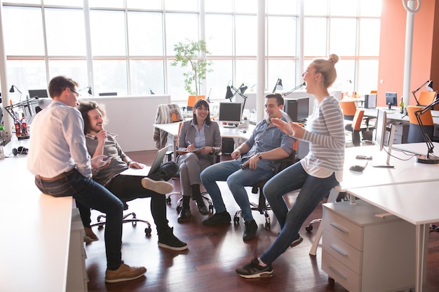 Groupe de jeunes gens d'affaires discutant d'un plan d'affaires au bureau