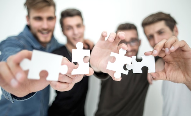 Groupe de jeunes avec des pièces de puzzle le concept de résolution du problème