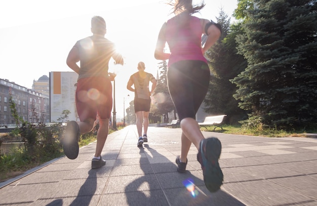 Photo groupe de jeunes sportifs faisant du jogging le matin ensoleillé de la ville