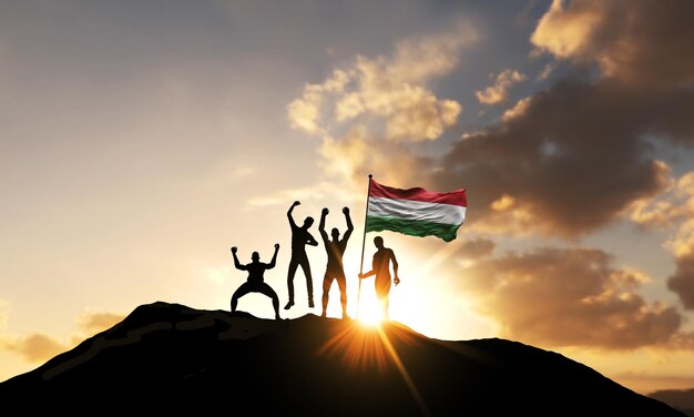 Un groupe de personnes célèbrent au sommet d'une montagne avec le rendu du drapeau de la hongrie