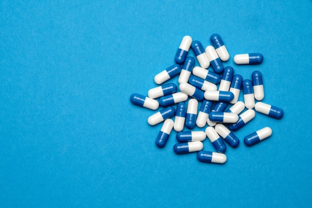 groupe de pilules ou de capsules sur fond bleu