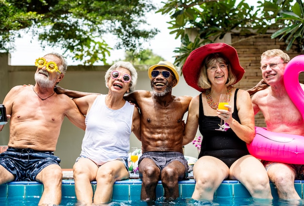 Groupe de seniors divers au bord de la piscine profitant de l&#39;été ensemble