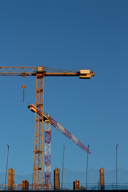 Grue de construction jaune sur fond bleu profond