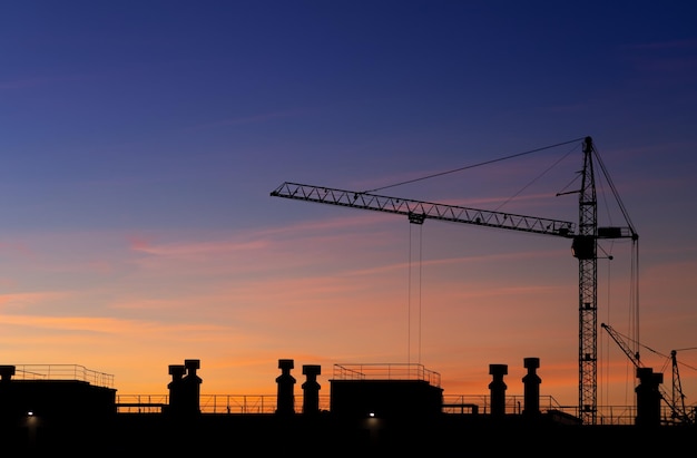 Grue de tour de construction sur fond de ciel coucher de soleil