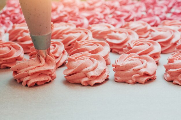 Guimauves faites maison rose sur un parchemin blanc