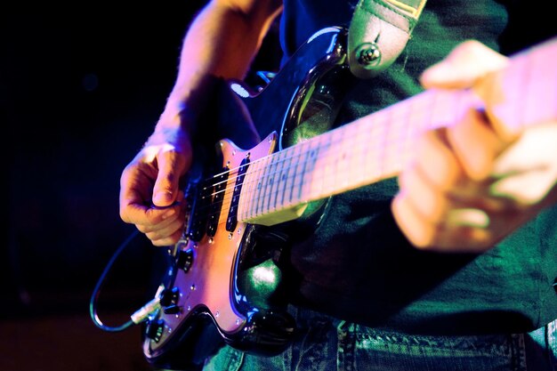 Guitariste.Close up image of guitar player on stage.Live music and music band