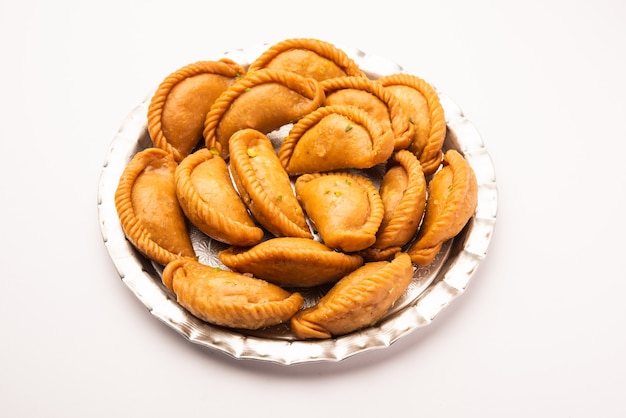 Gujiya ou gujia ou karanji. boulettes sucrées faites pendant le festival de holi et diwali, servies dans une assiette