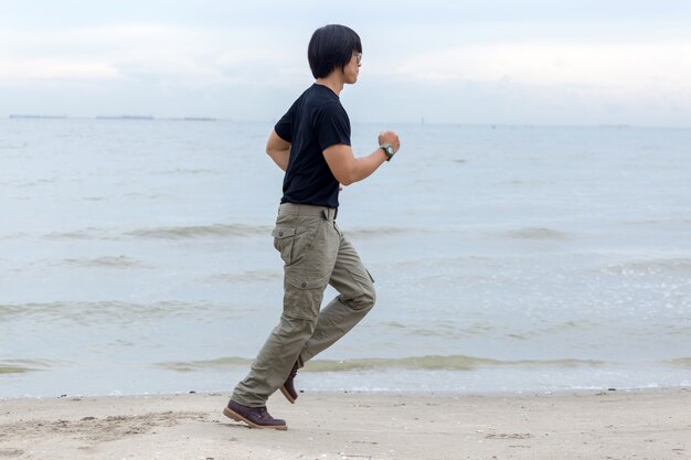 Guy portant des pantalons cargo et debout sur la plage