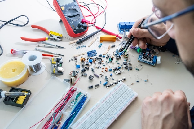 Guy tenant des pièces électroniques avec sa main