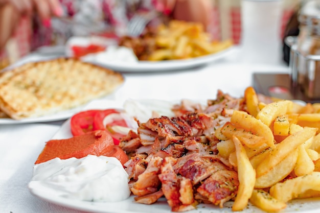 Gyros grecs sur une assiette avec frites et légumes