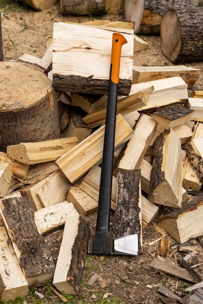 Photo hache professionnelle et bois de chauffage coupé dans la cour de la maison