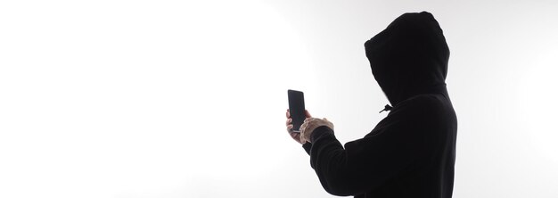 Hacker Anonymous et masque facial avec smartphone à la main