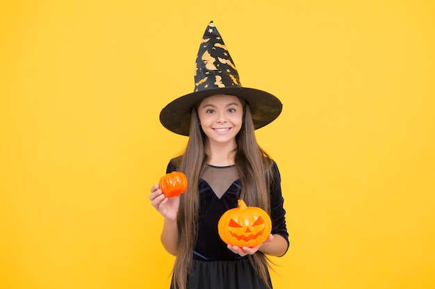 Halloween kid in witch hat hold citrouille jack o lantern pour la sorcellerie citrouille d'halloween