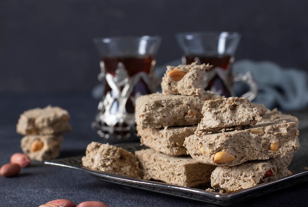 Halva de tournesol sucré avec cacahuète sur plateau métallique sur fond gris foncé Format horizontal