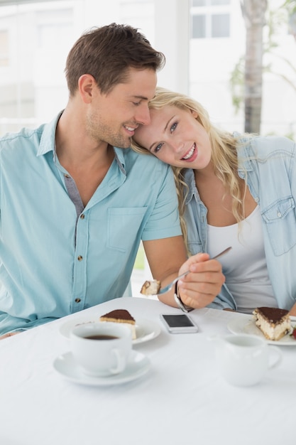 Hanche jeune couple ayant le désert et le café ensemble