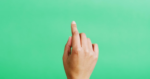 Hand click and mockup space in studio gesture and point with scroll empty and green background Person finger and interface or responsive display with user experience touch and virtual screen
