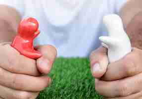 Photo hand holding mock up couple hugging on grass floor déçu par l'amour et le concept de la saint-valentin