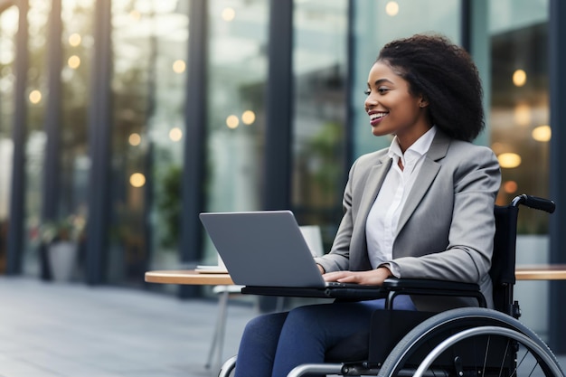 Handicap handicap une femme employée professionnelle en fauteuil roulant travaillant sur son ordinateur portable en dehors de la mobilité