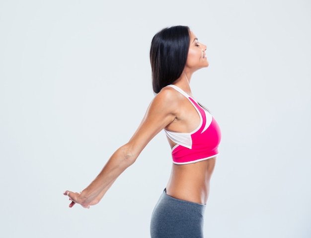 Happy fitness woman stretching mains