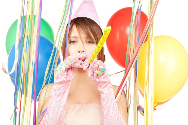 Happy teenage girl with balloons over white