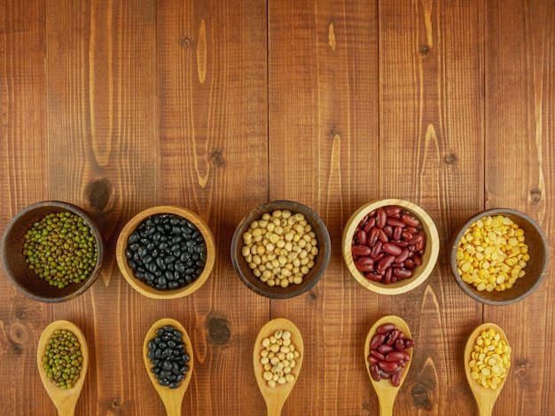 Photo haricots assortis dans des bols sur une table en bois