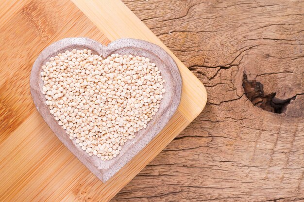 Haricots de quinoa dans un bol sur fond de bois