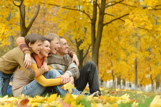 Héhé de quatre personnes se détendre dans un parc en automne