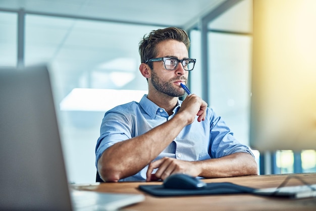 Hell figure it out Photo d'un jeune homme d'affaires travaillant sur un ordinateur dans un bureau