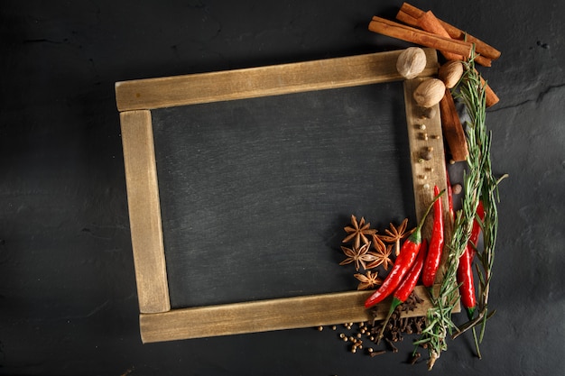 Herbes et épices avec tableau noir pour texte ou recettes.