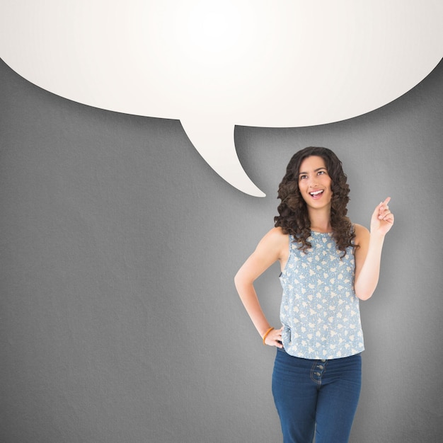 Heureuse belle brune posant contre la bulle de dialogue