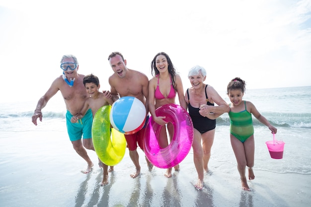 Heureuse famille multi-génération en cours d'exécution à la plage
