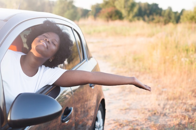 Heureuse femme afro-américaine dans une voiture, mode de vie