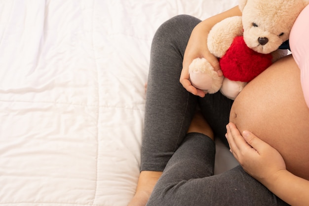 Heureuse femme enceinte et bébé qui attend.