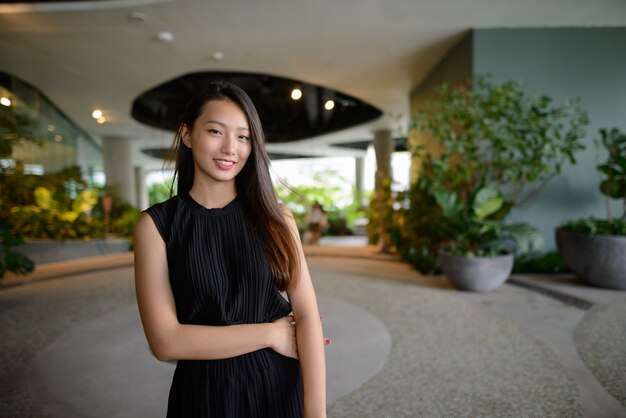 Heureuse jeune belle femme d'affaires asiatique dans le jardin intérieur