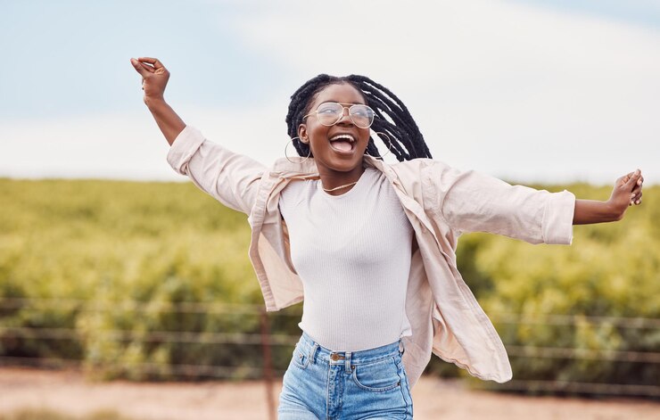 Photo heureuse liberté et excitée avec une femme noire dans la nature et voyager pour la paix se détendre et la jeunesse voyage aventure et bonheur avec une fille profitant de l'extérieur pour les vacances d'été et les vacances