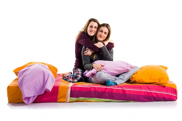 Heureuses soeurs jouant sur le lit