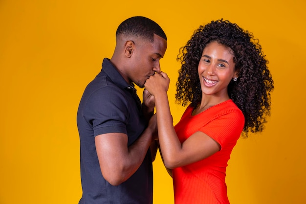 Heureux et aimant couple afro sur fond jaune Saint Valentin