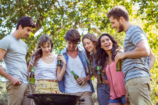 Heureux amis dans le parc ayant un barbecue