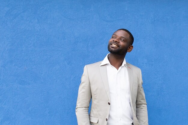 L'heureux et beau afro-américain sur fond bleu