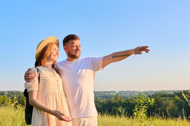 Heureux couple d'âge moyen regardant au loin à l'horizon