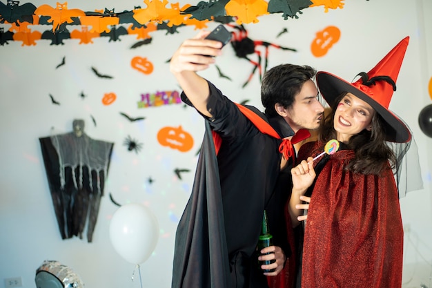 Photo heureux couple d'amour en costumes et maquillage pour une célébration d'halloween