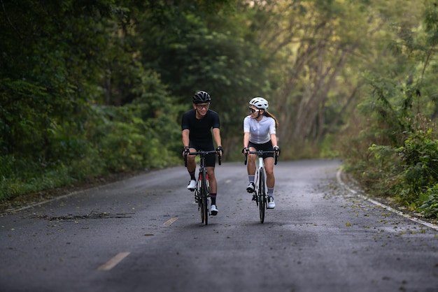 Heureux couple faire du vélo ou faire du vélo sur la campagne pour un style de vie sain
