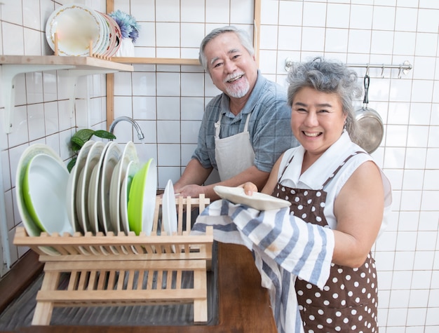 Heureux Couple De Personnes âgées Asiatique Aîné, Laver La Vaisselle Dans L'évier à La Maison Dans La Cuisine à La Maison.