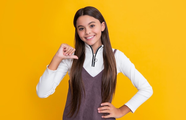 Heureux enfant aux cheveux longs sur fond jaune