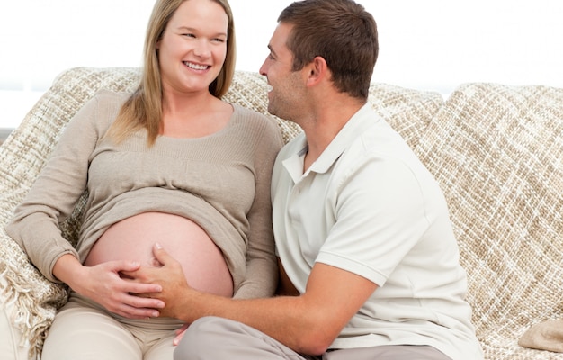 Heureux homme touchant le ventre de sa femme enceinte