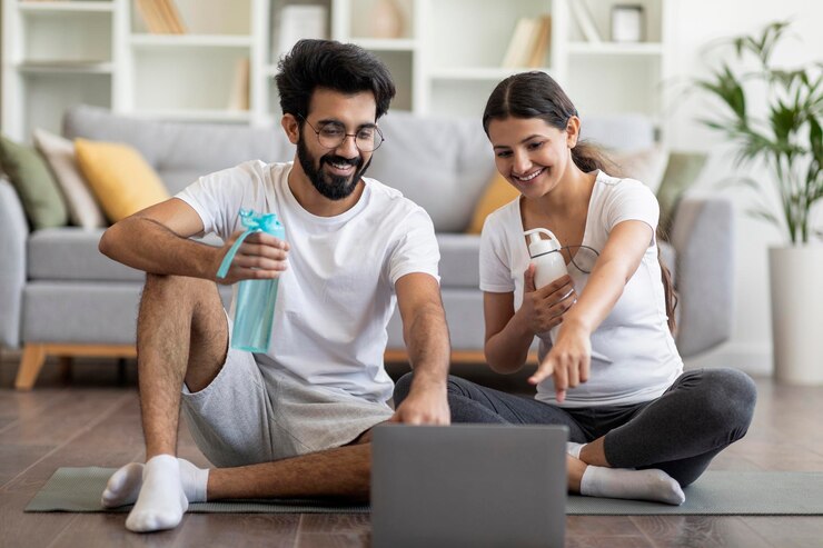 Photo heureux jeune couple indien choisissant des tutoriels en ligne sur ordinateur portable pour la formation à domicile