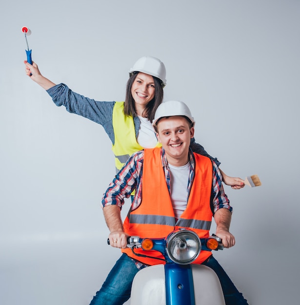 Heureux jeune couple à moto. Shopping pour la construction