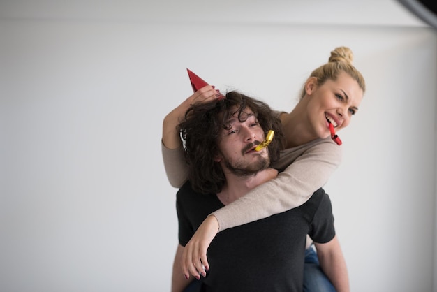 heureux jeune couple romantique amoureux célébrant et soufflant des décorations de confettis à la fête du nouvel an et des charismes